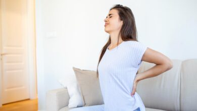 woman trying to maintain posture for back pain relief